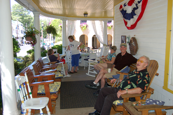 Friends gather on the porch by Bruce Stambaugh