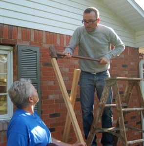 Driving tomato stakes by Bruce Stambaugh