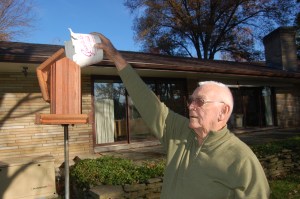 Filling the feeder by Bruce Stambaugh