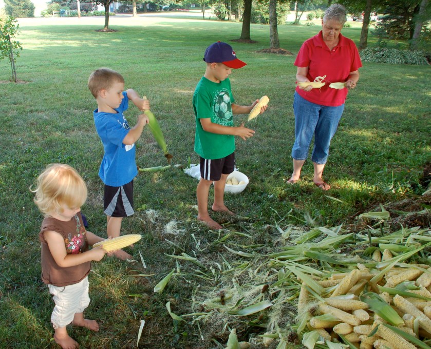 Husking corn by Bruce Stambaugh